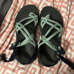 Black chaco’s with teal colored straps